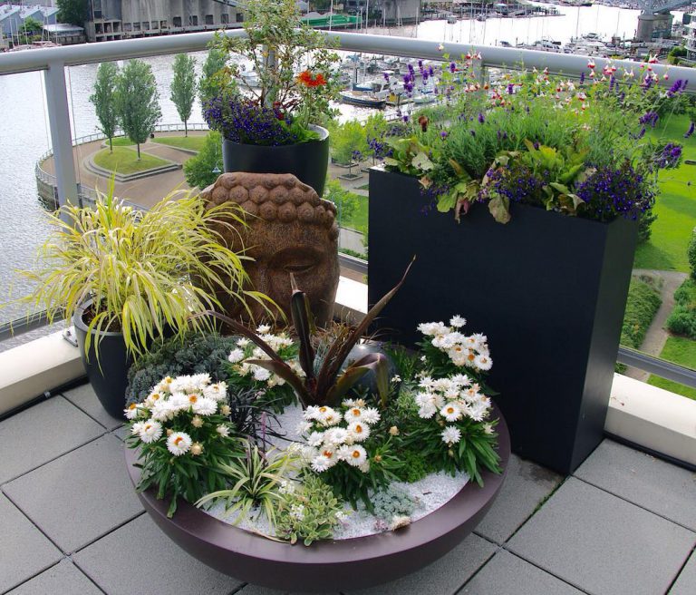 Stylish outdoor planter design by Elemental Gardens in a small waterfront patio setting.