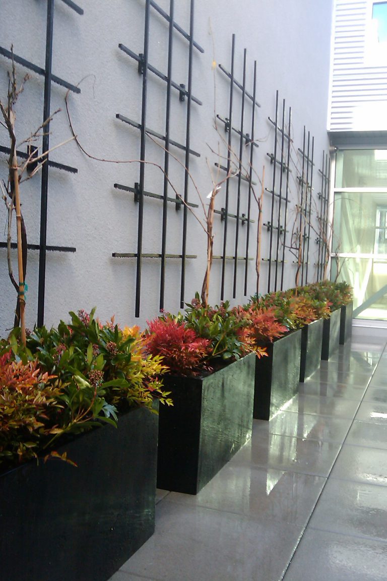 Large rectangular outdoor planters in commercial-grade fiberglass for modern landscaping in any weather.