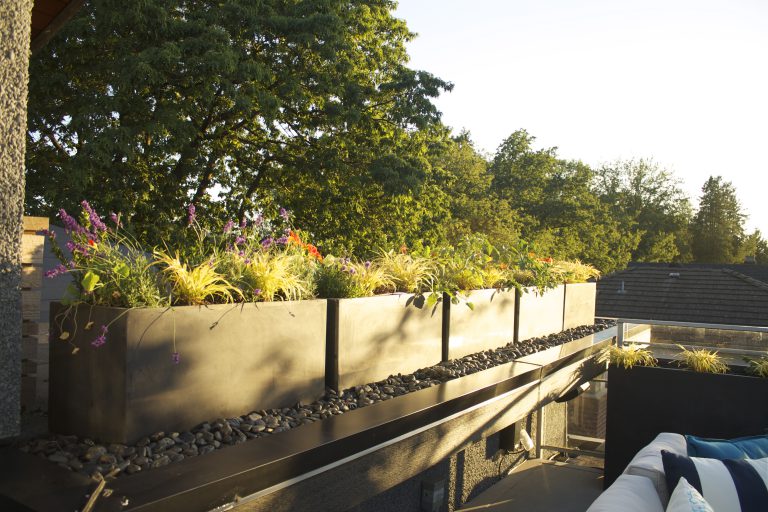 Charcoal rectangular outdoor planters for sleek, modern landscaping and added privacy.
