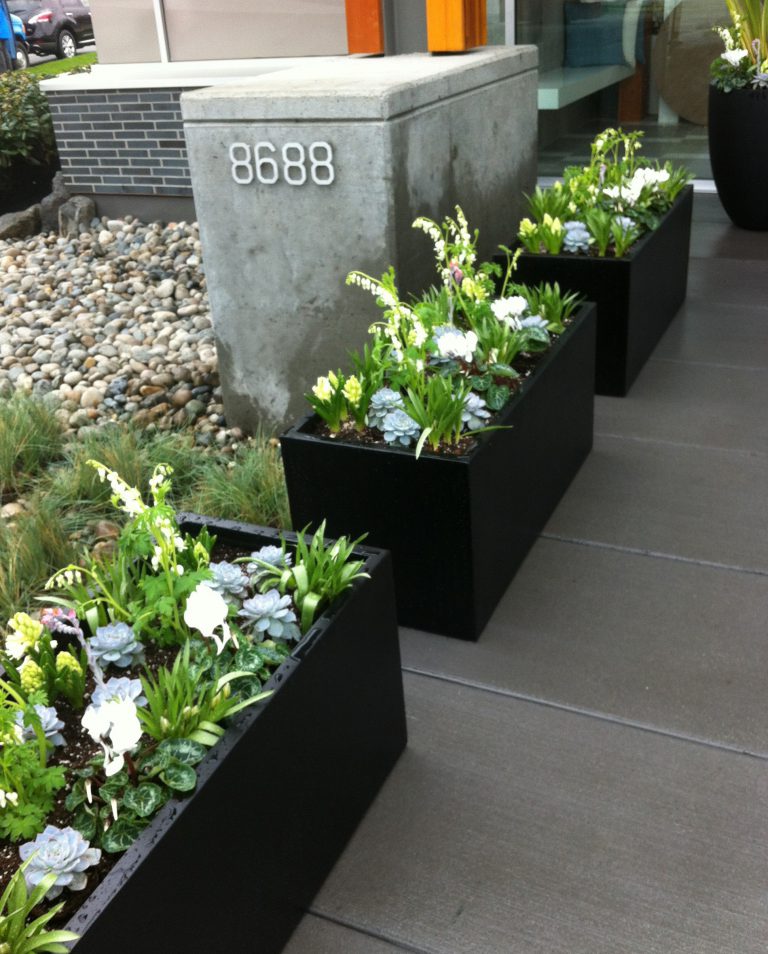 Lawrence rectangular fiberglass outdoor planters lining a modern entryway.