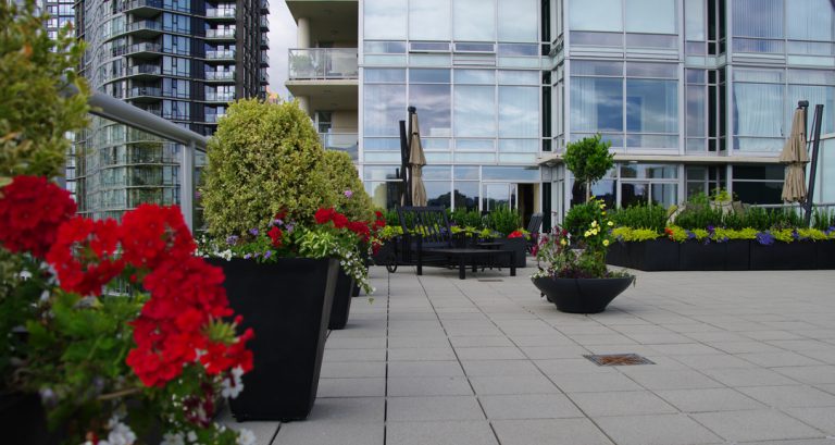 A variety of Carleton Line outdoor planters installed on a large downtown deck in Vancouver by Elemental Garden Design.