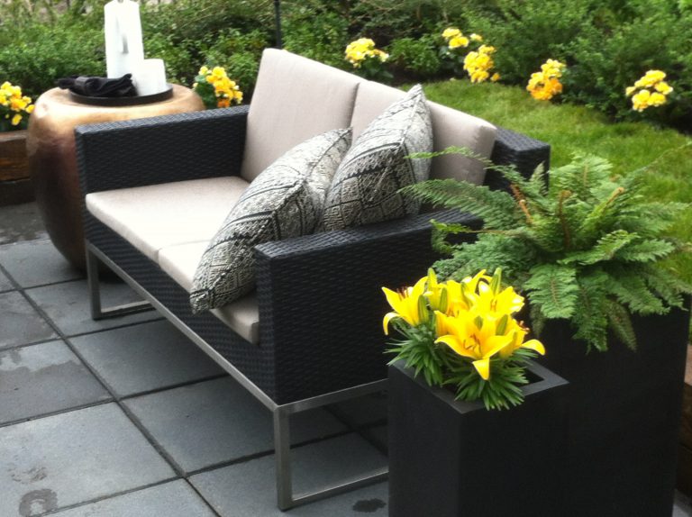 Black Tall Ruben planters fabricated from commercial-grade fiberglass for a lively patio space.